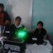 Aadhaar card held next to a smartphone